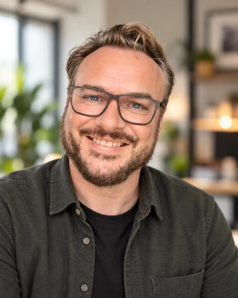 Mark Hebblewhite smiling and wearing glasses