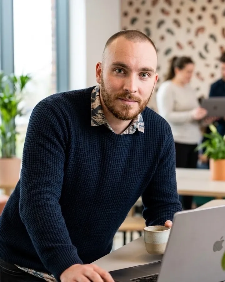 Milos Grgurov working at a laptop in the office